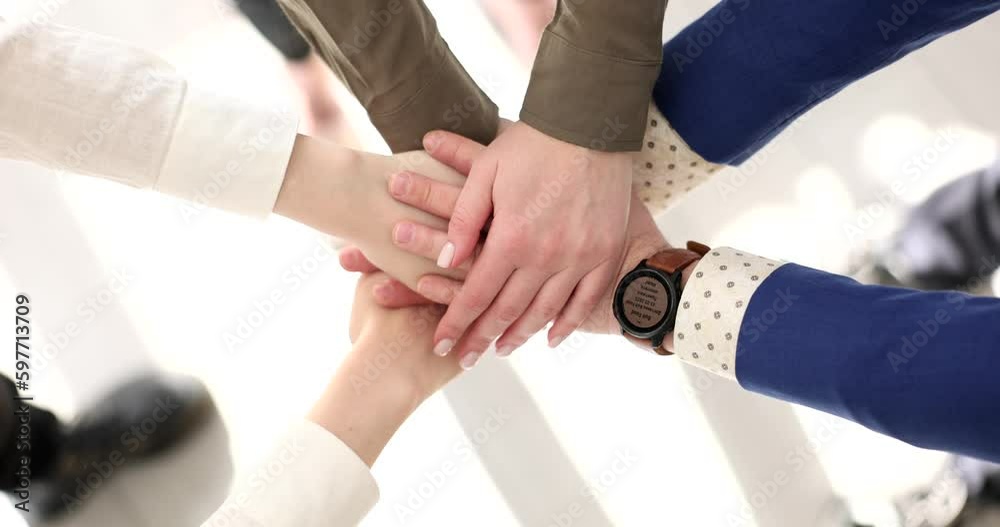 Business team members join hands during team-building activities in office premise slow motion. Colleagues cooperation for collective growth Business team members join hands during team-building activities in office premise slow motion. Colleagues cooperation for collective growth