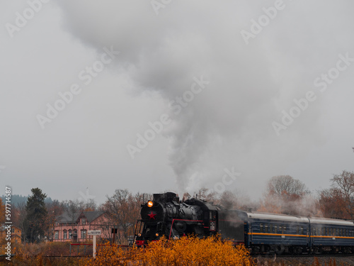 Vintage soviet steam train locomotive. Karelian Express, autumn landscape