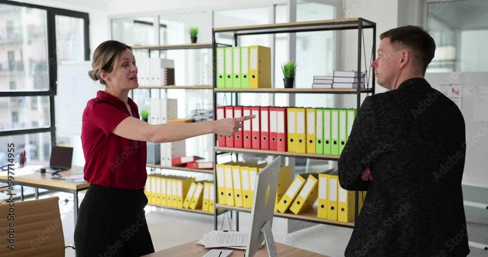 Woman boss gets angry and swears at calm man subordinate. Office worker walks up to woman and hits head on table at workplace slow motion Woman boss gets angry and swears at calm man subordinate. Office worker walks up to woman and hits head on table at workplace slow motion