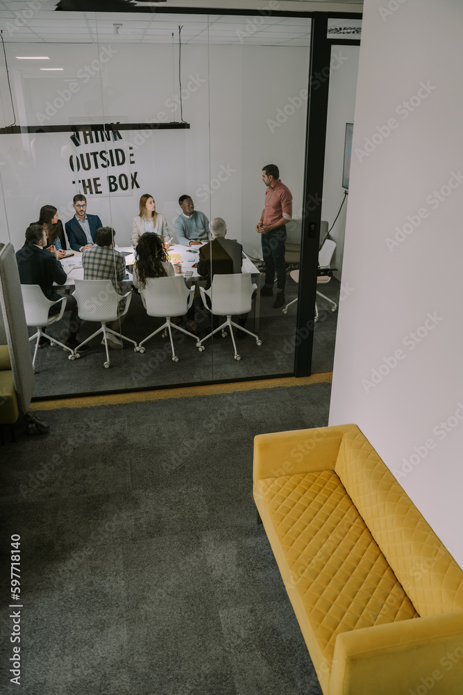 High view photo of people brainstorming in a modern meeting room