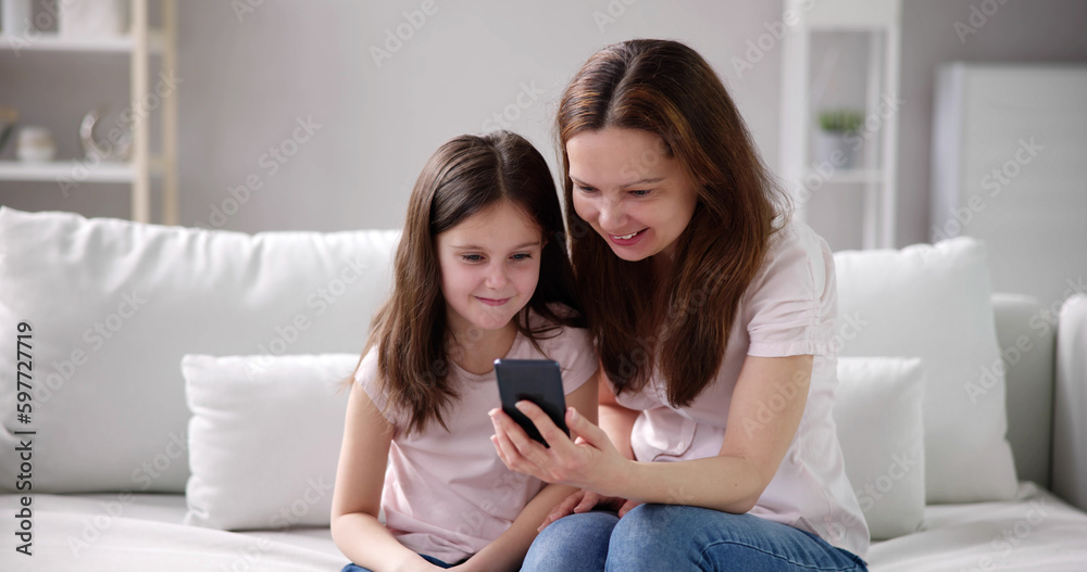 Woman Texting On Phone With Child Woman Texting On Phone With Child