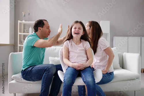 Parent Sitting On Sofa Quarreling Loudly