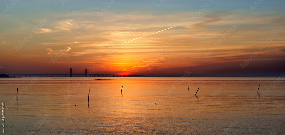 Red sunset descending behind the Öresund brigde in Malmö, Sweden Red sunset descending behind the Öresund brigde in Malmö, Sweden