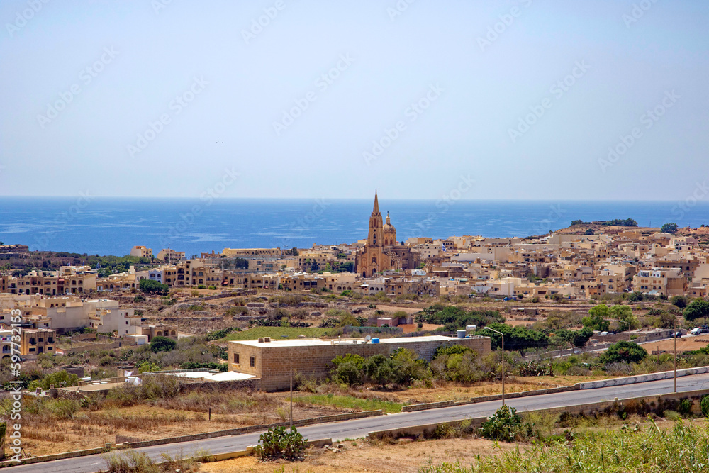 Parish Church of Our Lady of Loreto is a Roman Catholic neo-gothic parish church at island of Gozo with mediterranean sea in the background. Photo taken August 10th, 2017, Gozo, Malta. 