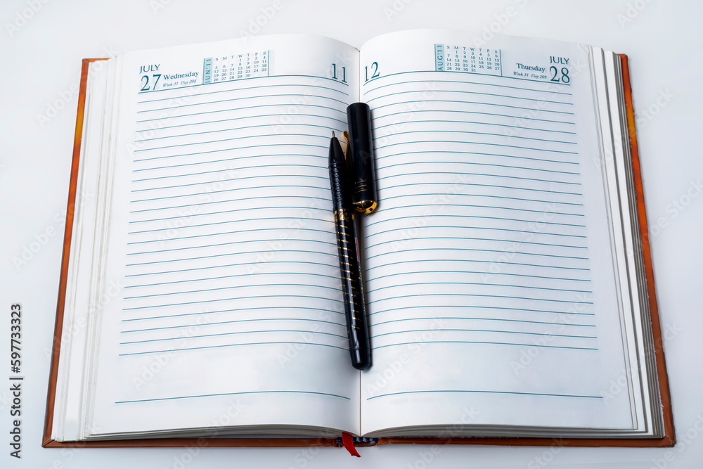 Open notebook with pen on white background, business and education concept Open notebook with pen on white background, business and education concept