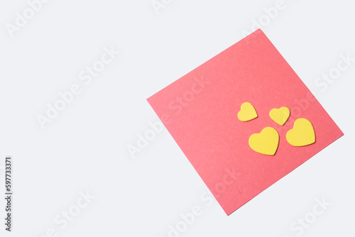 Valentine's day greeting card with yellow hearts on pink paper with copy space for text.