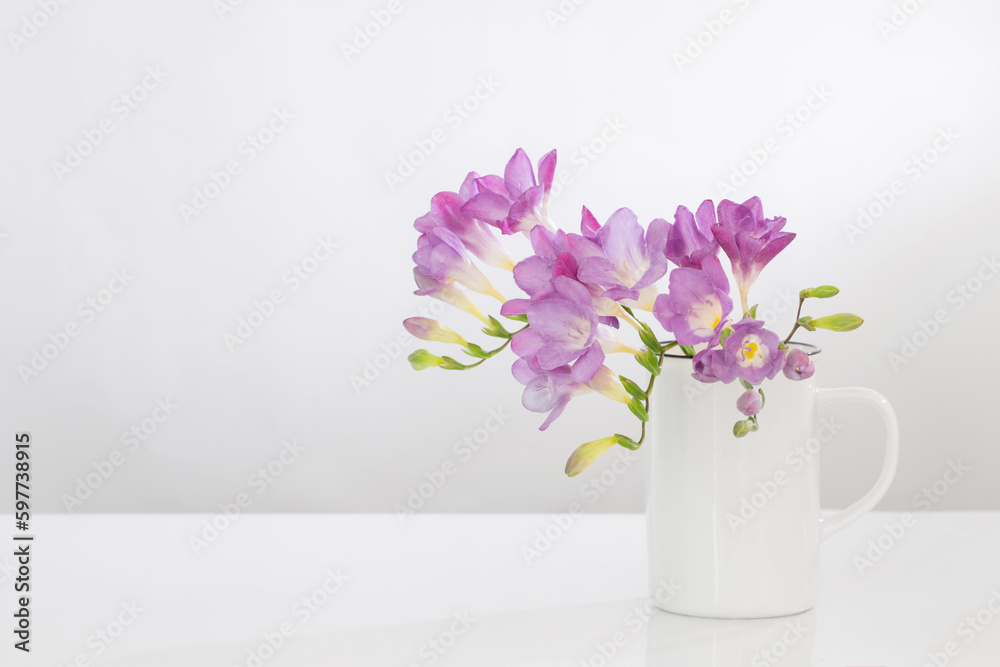 purple freesia in glass vase on white background purple freesia in glass vase on white background
