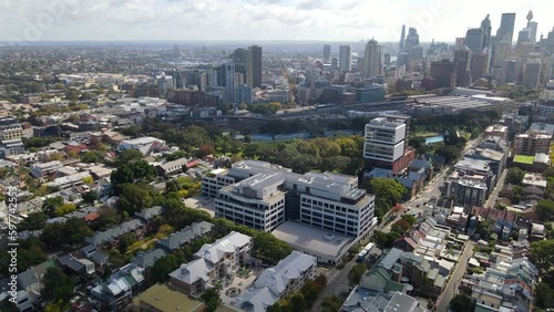 Aerial drone pullback reverse view of Redfern in inner Sydney, NSW Australia looking toward Ultimo and Haymarket    photo