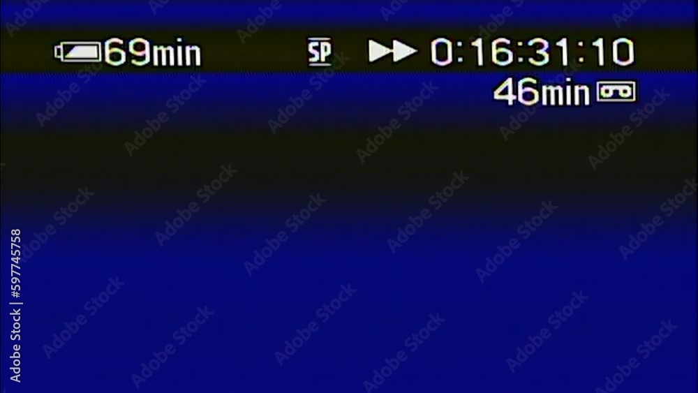 Real analog video recording of strong glitches, distortion in signal #2. VHS or MiniDV retro style overlay icons - fast forward. Camcorder tape heavy interference, noise and artifacts. Vintage style.