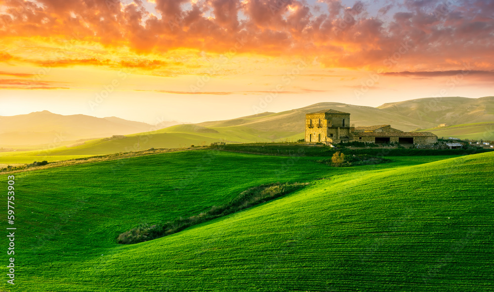green field in countryside at sunset in the evening light. beautiful spring landscape in the mountains. grassy field and hills. rural scenery green field in countryside at sunset in the evening light. beautiful spring landscape in the mountains. grassy field and hills. rural scenery