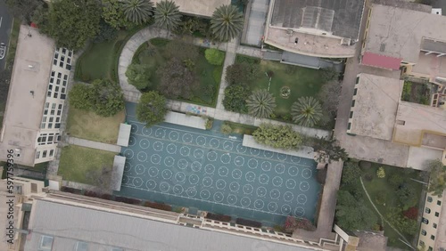 4K Aerial Drone Top Down descent and rotate over playground in Lima, Peru. Trees visible photo