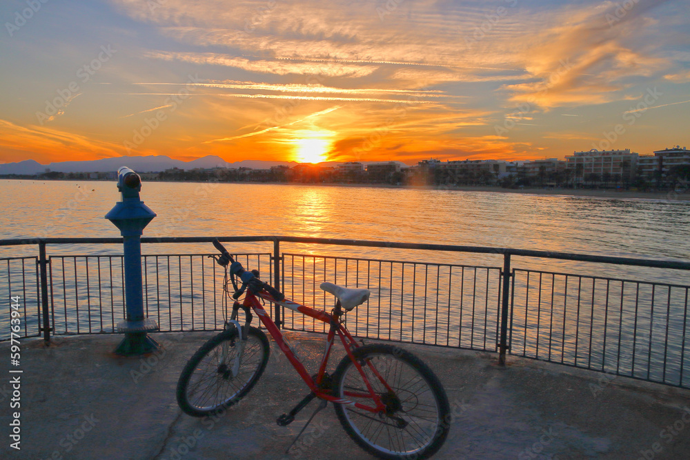 Fototapeta premium Watching the sunset at the end of the bike ride.