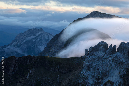 fog rolling over mountain peaks in dusk