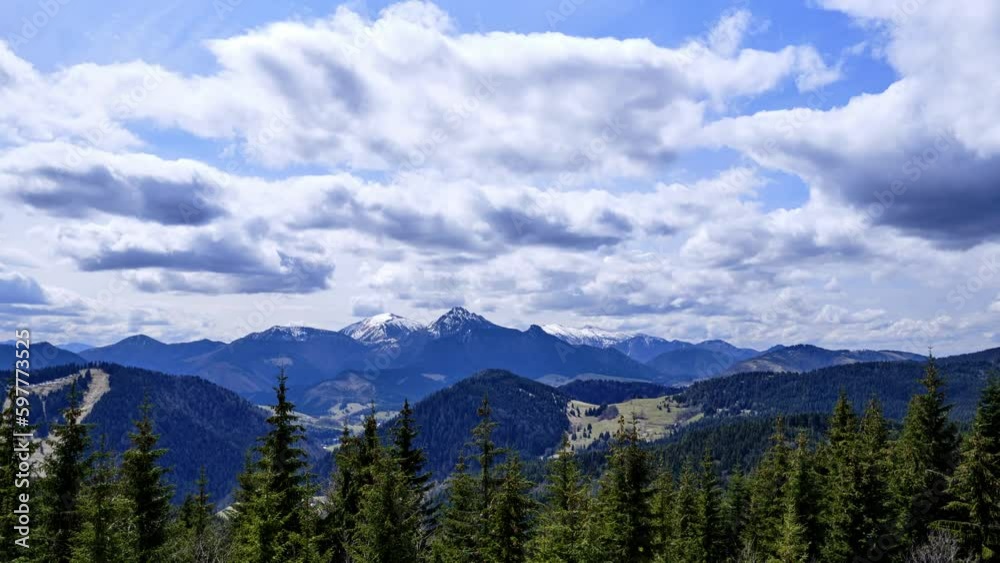 Mountain hilly rural scenery, fluffy clouds. Spruce trees in the foreground. time lapse video Mountain hilly rural scenery, fluffy clouds. Spruce trees in the foreground. time lapse video