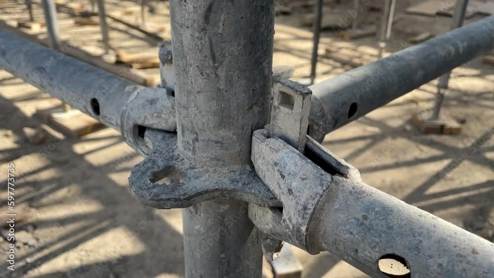 Wedge metal scaffolding. Steel scaffolding and mounting parts for strength on construction sites or concert venues. close-up Wedge metal scaffolding. Steel scaffolding and mounting parts for strength on construction sites or concert venues. close-up