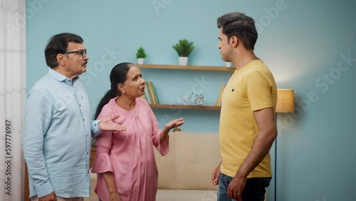 angry Indian adult son arguing with elderly senior parents at home - concept of irresponsibility, family problems and generation gap