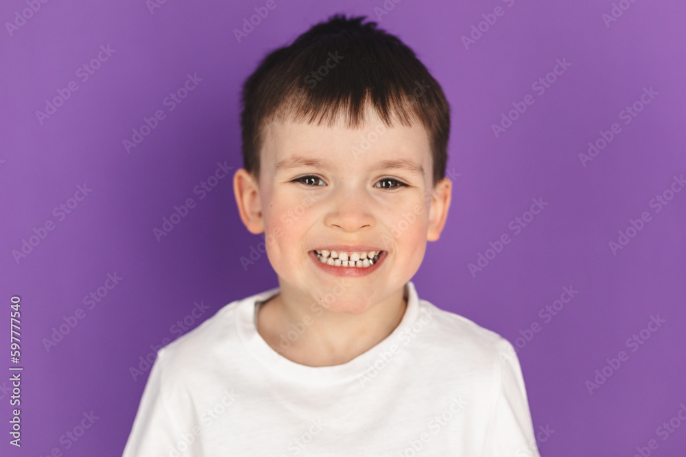 Portrait of happy joyful laughing beautiful little boy wear white t-shirt, look at camera, smiling isolated on purple violet background. Portrait of happy joyful laughing beautiful little boy wear white t-shirt, look at camera, smiling isolated on purple violet background.