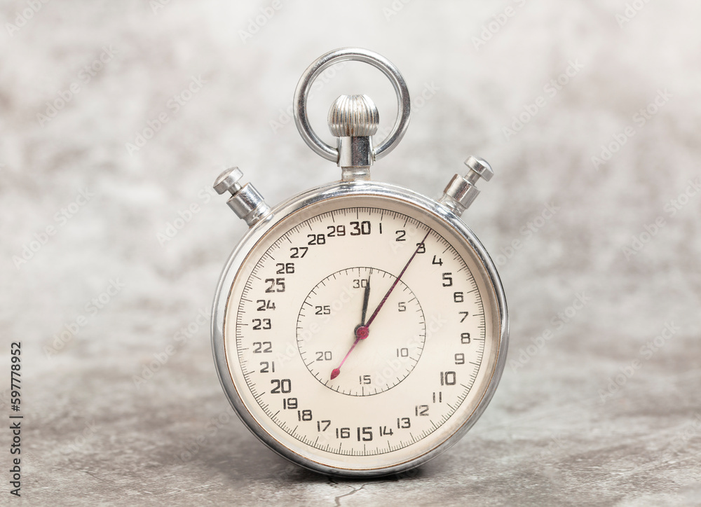 Old stopwatch on a gray background