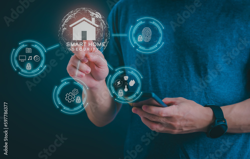 Man using a smartphone, controlling an intelligent home automation system Futuristic interface on a virtual screen Automation technology of things, concept Data connection with technology internet.