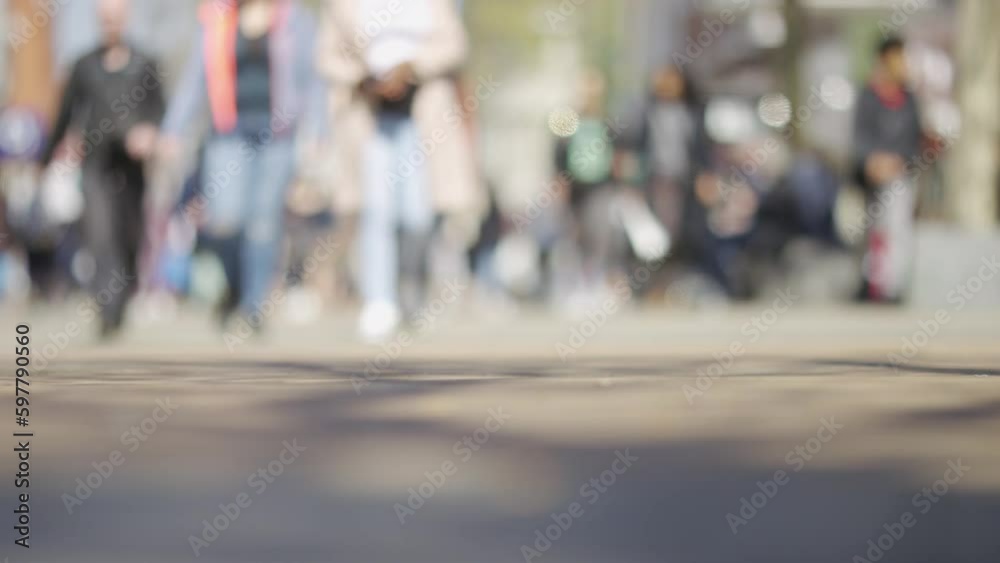Blurred background of pedestrians walking to camera on a busy shopping high street, in slow motion Blurred background of pedestrians walking to camera on a busy shopping high street, in slow motion