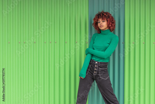 urban girl on the street with green wall background