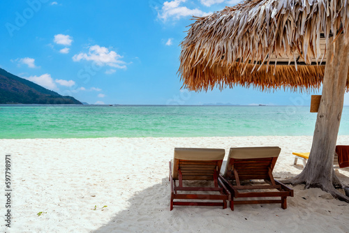 Sun bed and parasol at beautiful tropical white sand beach on sunny day  Summer vacation and Travel concept