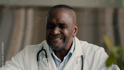 African ethnic doctor medical worker rub sore throat suffer from inflamed tonsils unhealthy mature man hurt swallow has covid-19 disease symptom coronavirus infection contagion virus health problem