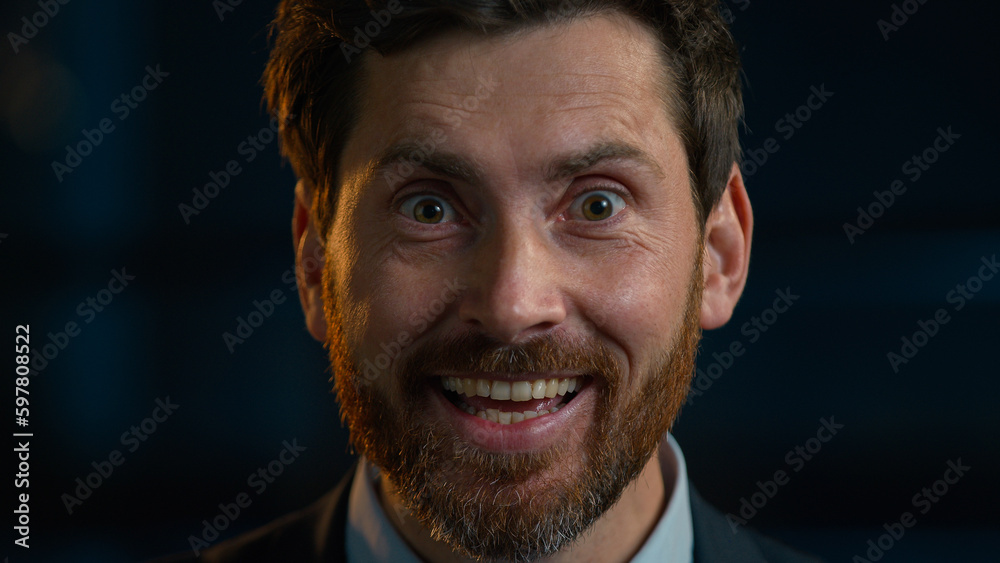 Portrait surprised shocked Caucasian adult bearded businessman middle-aged 40s man happy employee manager worker stand in evening office rejoice good news win surprise positive emotion wonder delight Portrait surprised shocked Caucasian adult bearded businessman middle-aged 40s man happy employee manager worker stand in evening office rejoice good news win surprise positive emotion wonder delight