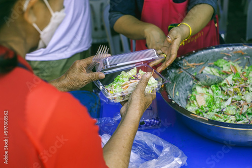 Volunteers give food to the poor : free food service to the sifter
