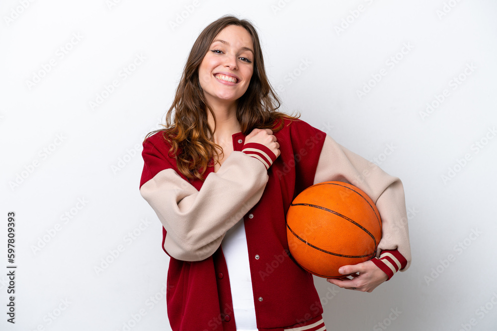 Young caucasian woman playing basketball isolated on white background celebrating a victory