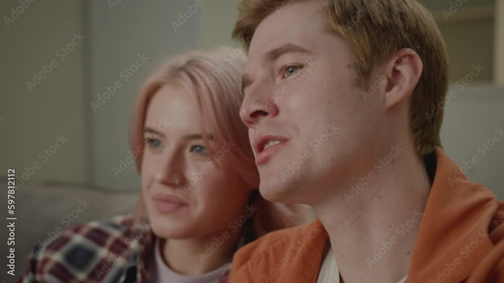 Couple Watching Tv Eating Popcorn Close Up. Boyfriend and girlfriend chatting and smiling sitting on couch at home. Couple Watching Tv Eating Popcorn Close Up. Boyfriend and girlfriend chatting and smiling sitting on couch at home.