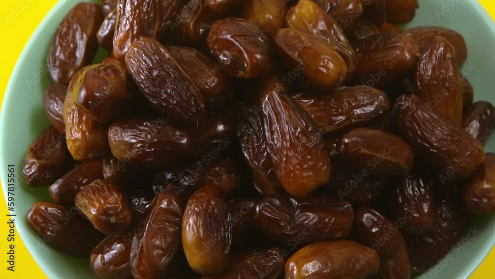 Dates. Dried date palm fruits. Healthy sweet snack food bowl. Pile of tasty dry dattes in plate. Date harvest symbolizing Ramadan. Dates. Dried date palm fruits. Healthy sweet snack food bowl. Pile of tasty dry dattes in plate. Date harvest symbolizing Ramadan.
