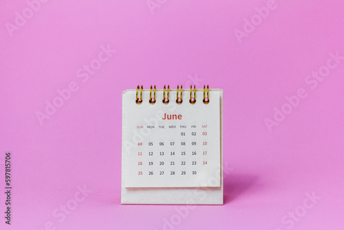 Calendar for June 2023 on a pink background.