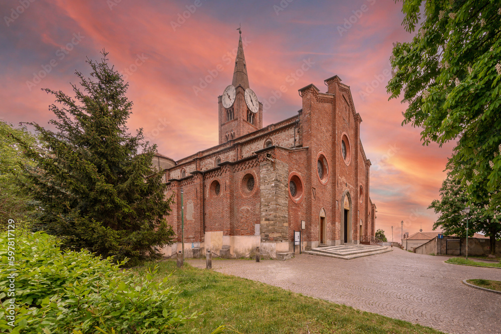 Pinerolo, Turin, Piedmont, Italy - April 29, 2023: Medieval church of San Maurizio 13th century with colorful sky at sunset