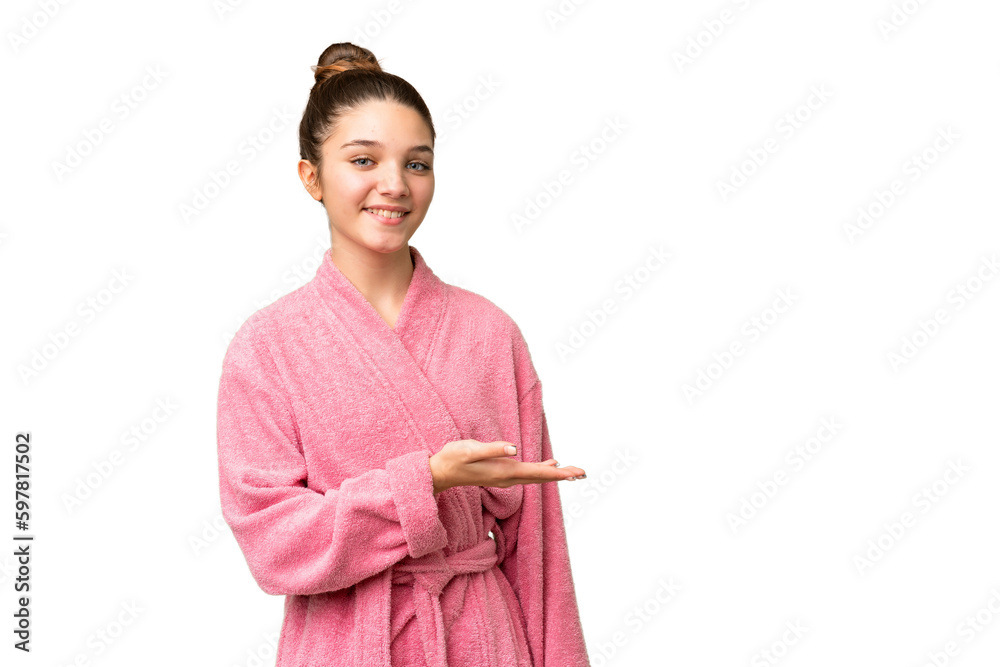 Teenager girl in a bathrobe over isolated chroma key background presenting an idea while looking smiling towards Teenager girl in a bathrobe over isolated chroma key background presenting an idea while looking smiling towards