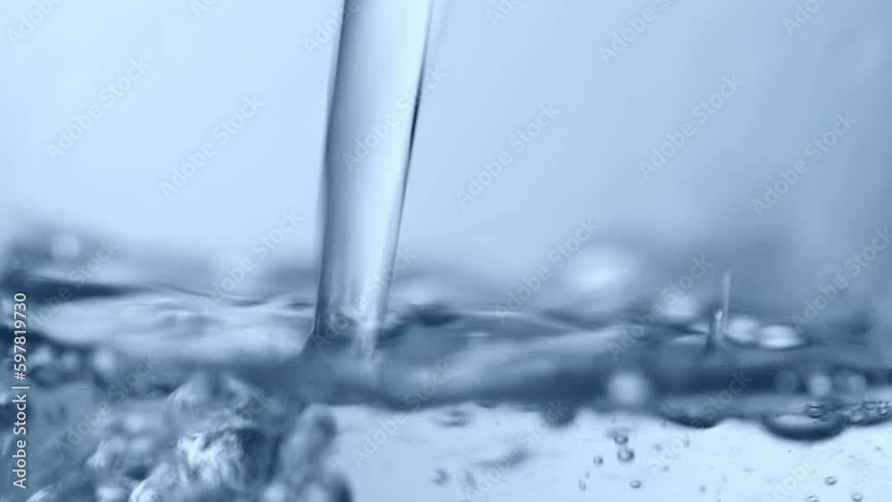 Pouring water. Closeup. Blue tone Pouring water. Closeup. Blue tone