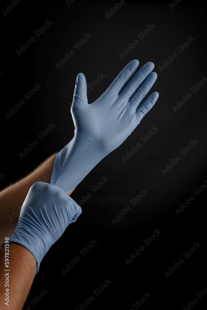 Doctor, hands in medical gloves, black background, doctor's hands, studio photo, medicine Doctor, hands in medical gloves, black background, doctor's hands, studio photo, medicine
