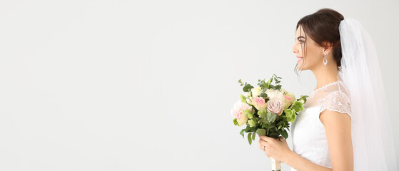 Beautiful young bride with bouquet of flowers on light background with space for text