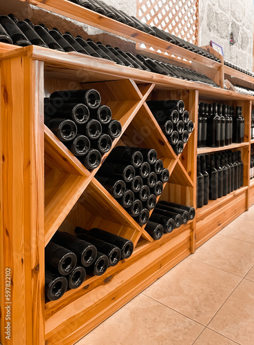 Obraz na plátně Wooden storage stand with bottles of wine in store