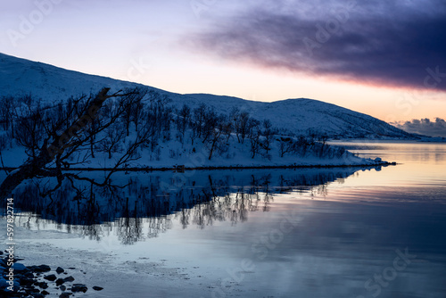 snowy landscape at sunset in coasline of tromso