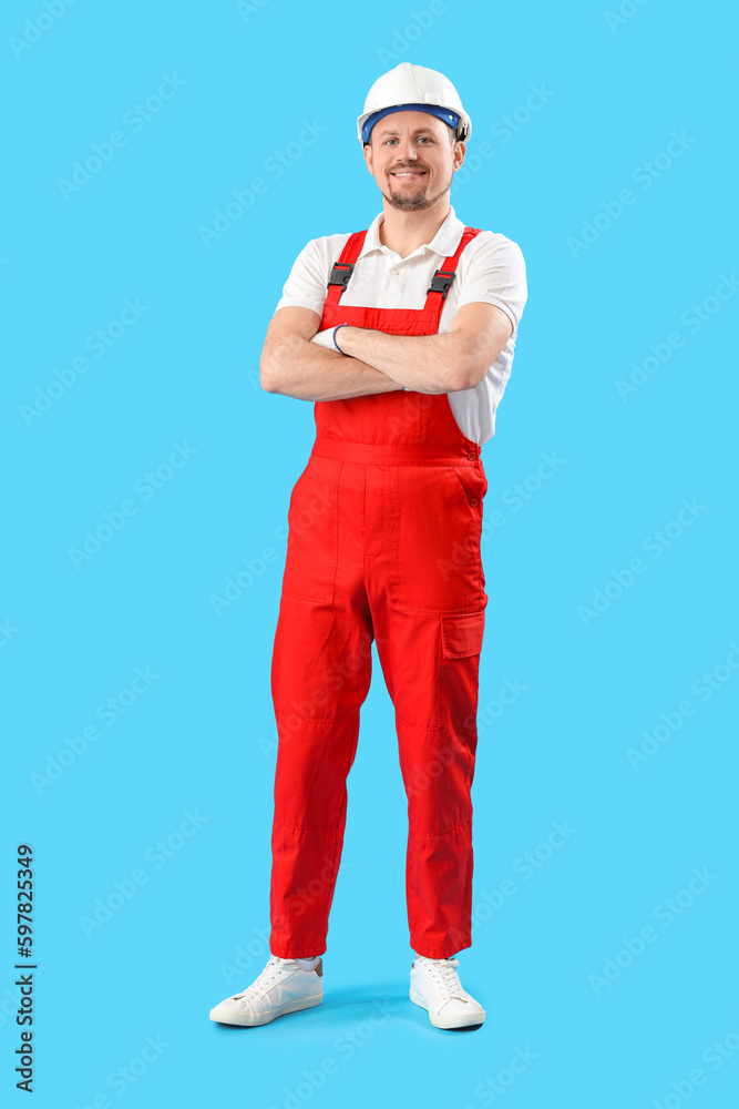 Male carpenter in hardhat on blue background Male carpenter in hardhat on blue background