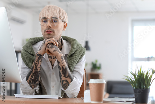 Young tattooed man working ...