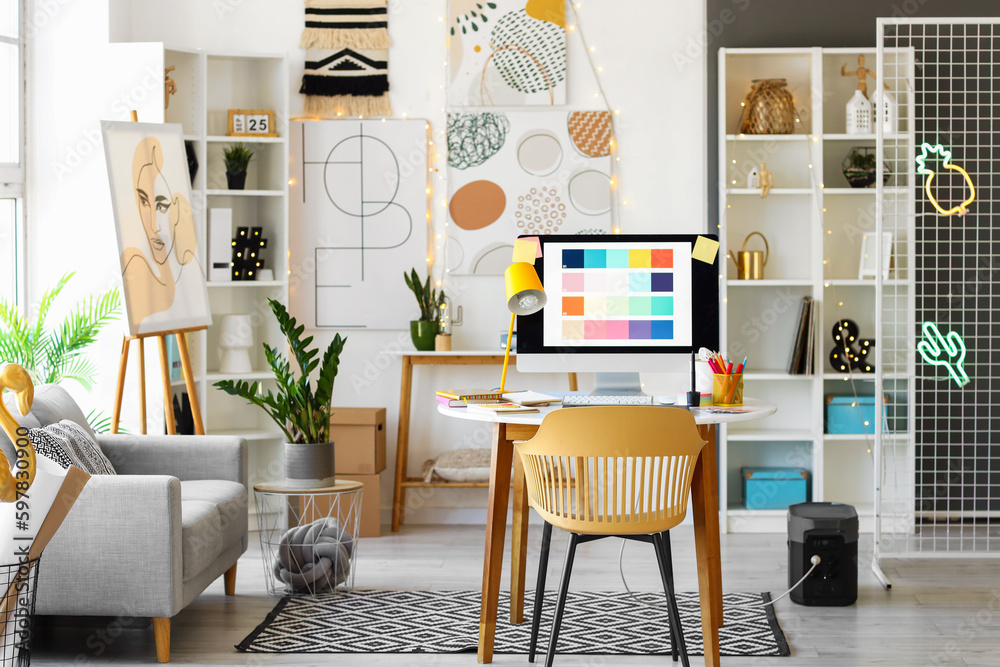 Interior of office with graphic designer's workplace and sofa Stock