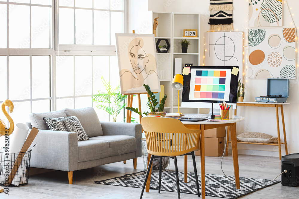 Interior of office with graphic designer's workplace and sofa Stock