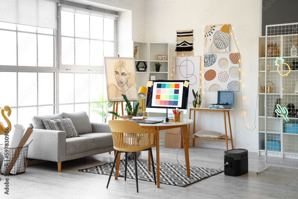 Interior of office with graphic designer's workplace and sofa Interior of office with graphic designer's workplace and sofa