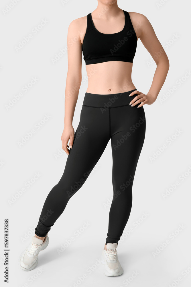 Sporty young woman in leggings on white background Sporty young woman in leggings on white background