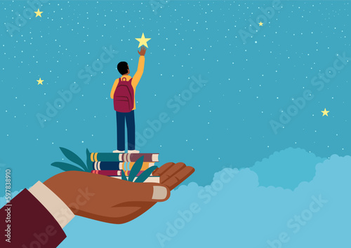 Black man hand lifting up a school afro boy to reach for the star