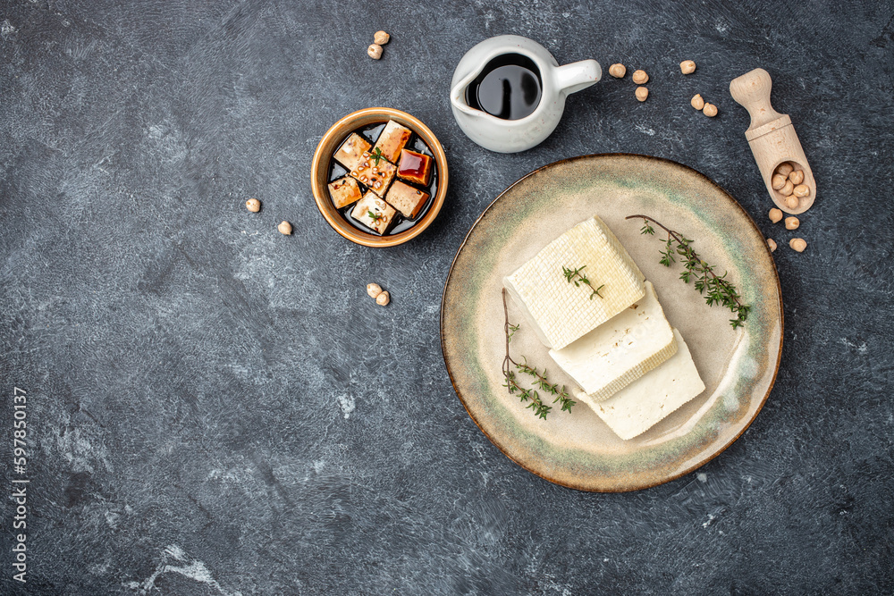 fresh tofu cheese on a dark background. banner, menu, recipe place for text, top view fresh tofu cheese on a dark background. banner, menu, recipe place for text, top view