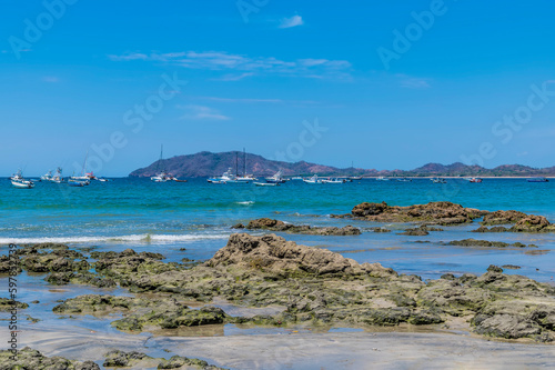 A view over rocky outcrops on the shoreline at Tamarindo in Costa Rica in the dry season photo