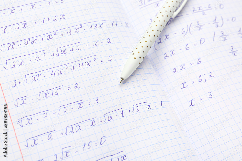Copybook with maths formulas and pen, closeup Copybook with maths formulas and pen, closeup